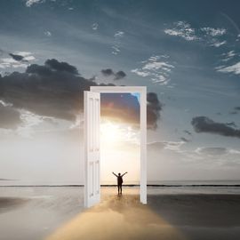 A person stepping to an open door, as though they are walking into freedom. 