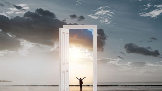 A person stepping to an open door, as though they are walking into freedom. 