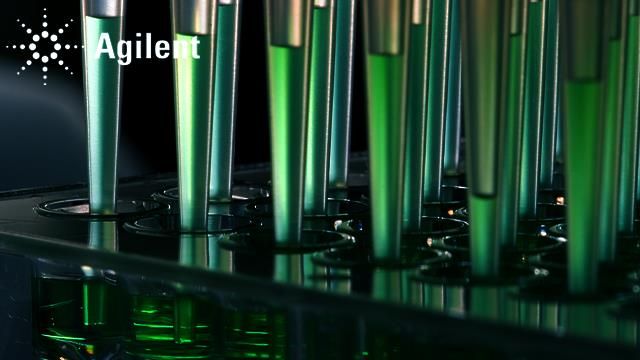 Pipette tips dispense green liquid into a 48-well plate. 
