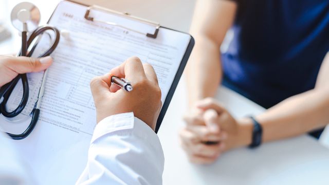 A doctor holding a clipboard.