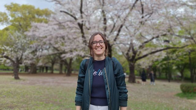 Dr. Cuella Martin standing in front of a blossoming tree.