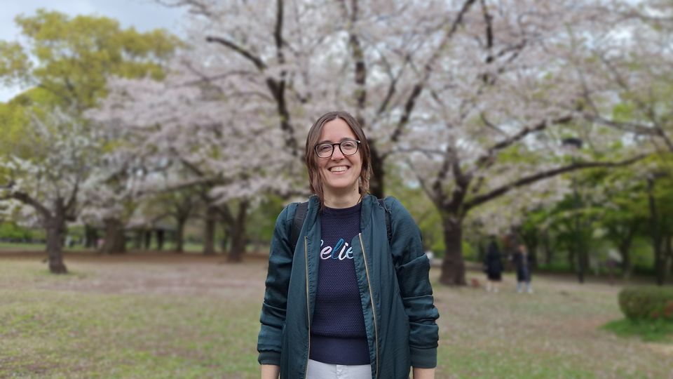 Dr. Cuella Martin standing in front of a blossoming tree.