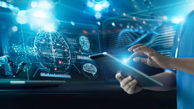 A research scientist using a tablet to perform AI-assisted research on the human brain