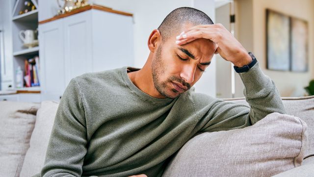 Man holding his head in pain.