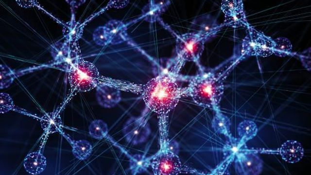 The image features interconnected nodes and lines, glowing with blue and red hues, resembling a visualization of atoms, molecules, or perhaps even neural networks. 