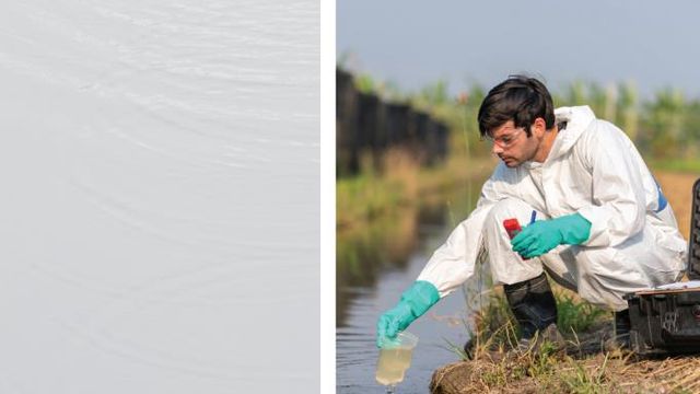 Scientist wearing PPE collecting a water sample from a river